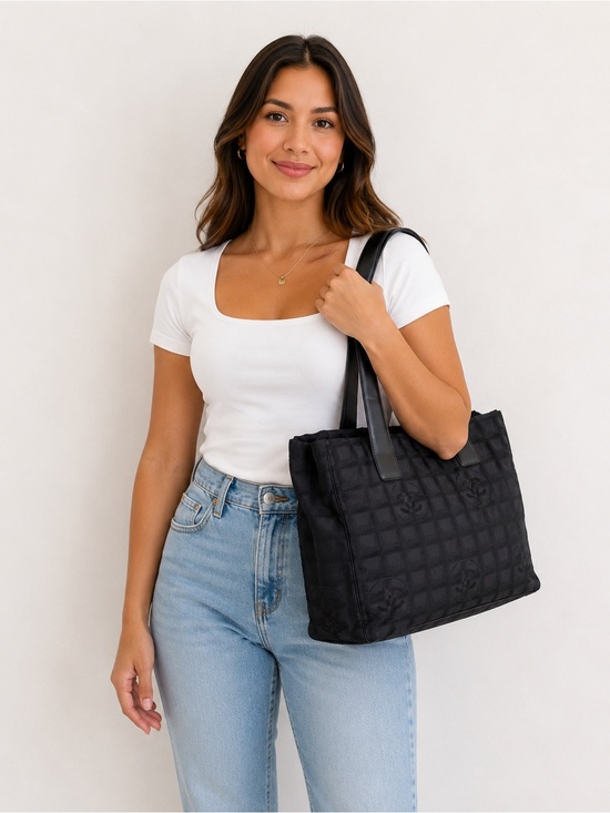 chanel travel tote bag Line in Black Canvas Weekly Lux Drop owned The New Travel Line tote bag features a nylon body with leather trim Chanel Black Nylon Travel Tote